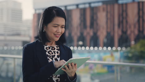 business woman using tablet in city