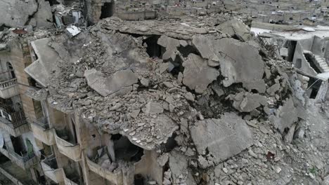 close view over ruins of buildings in aleppo, syria. we can see destroyed buildings in the street of the city - aerial view with a drone 4k