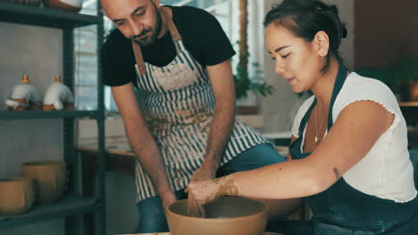 getting some hints and tips from the pottery guru