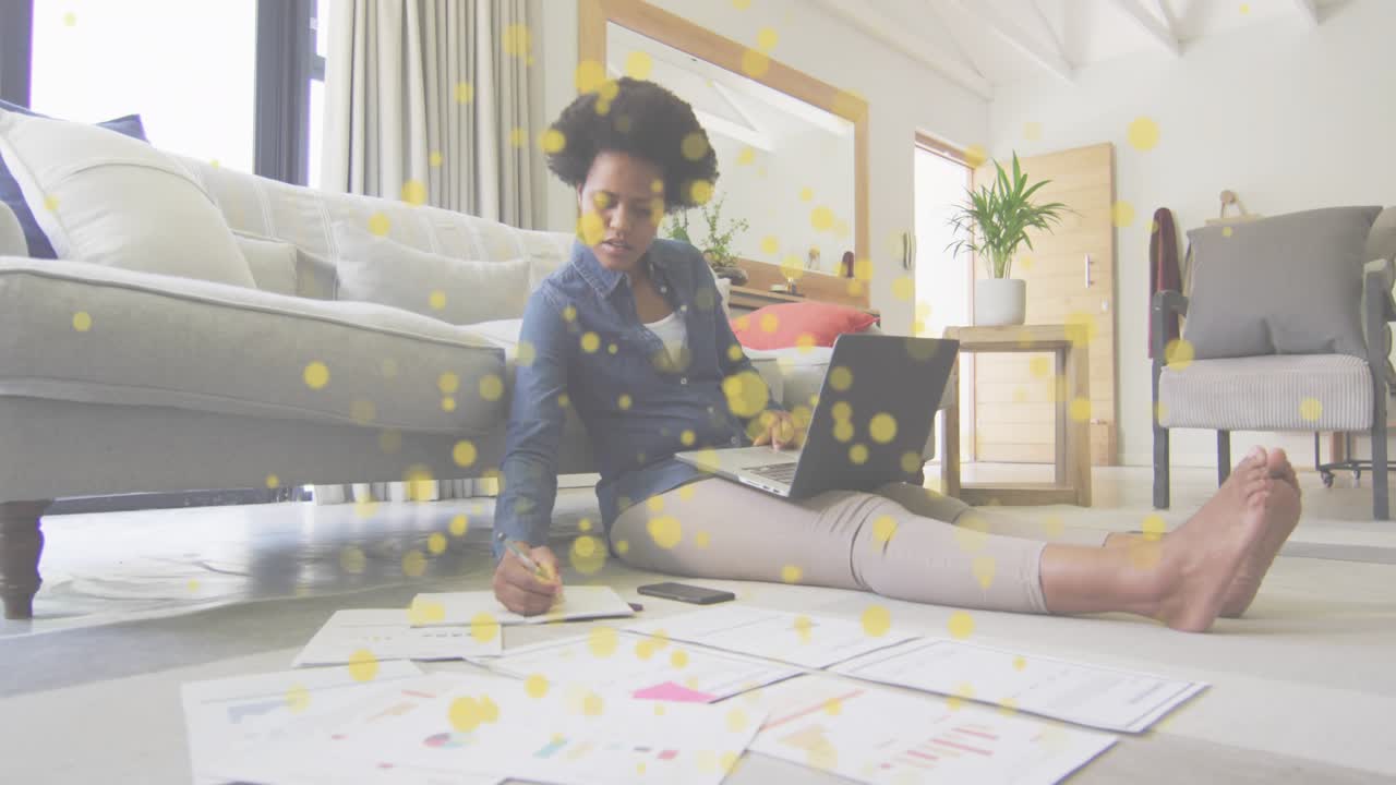 Woman typing on laptop initiating animated chart highlights on printed graphs for business analysis