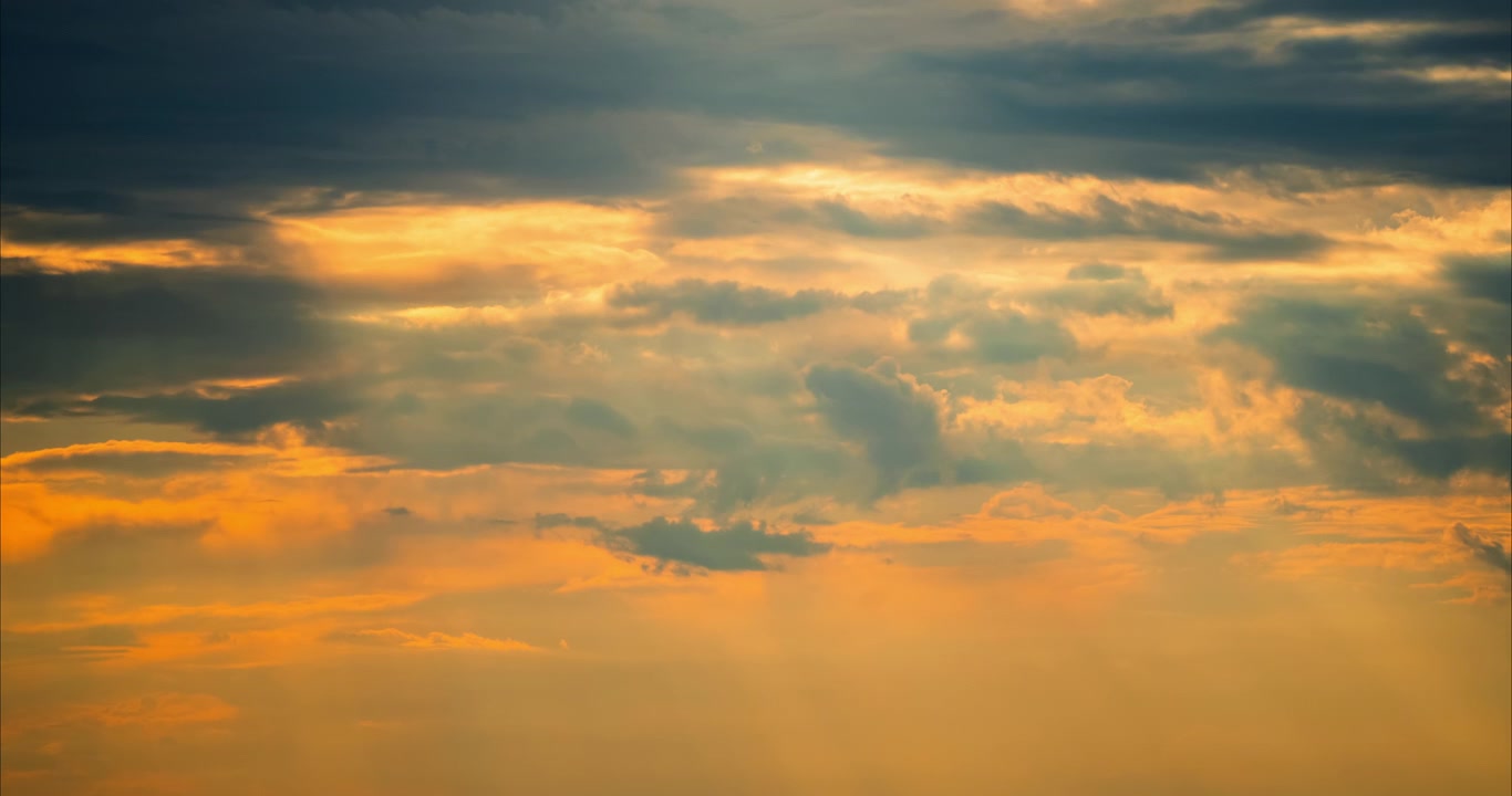 Dramatic Golden Sunset Sky with Moving Clouds and Sun Rays
