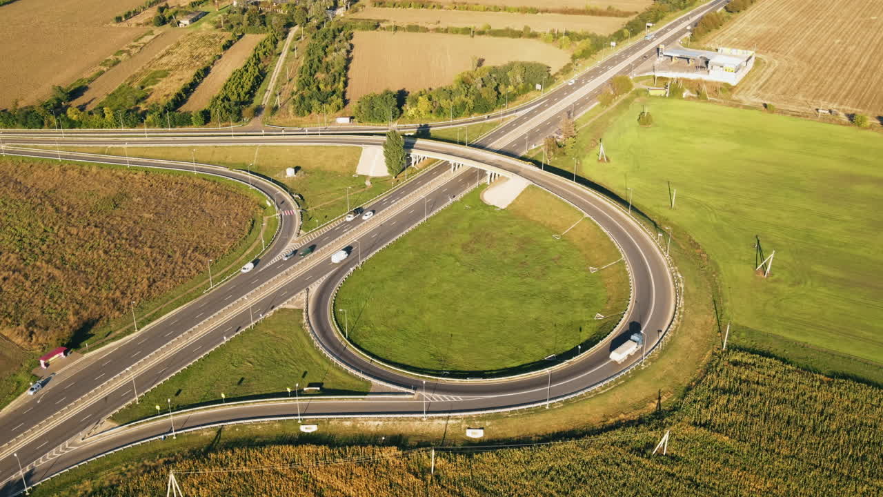 Aerial drone view of a road junction with moving cars and nature, greenery, fields, Moldova
