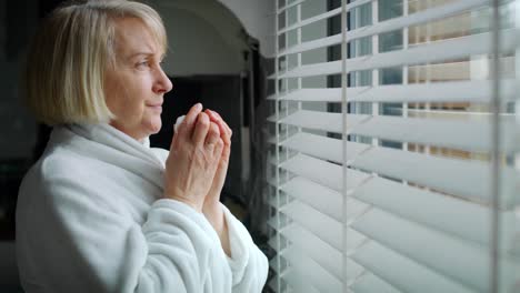 Video-of-sick-senior-woman-looking-out-the-window