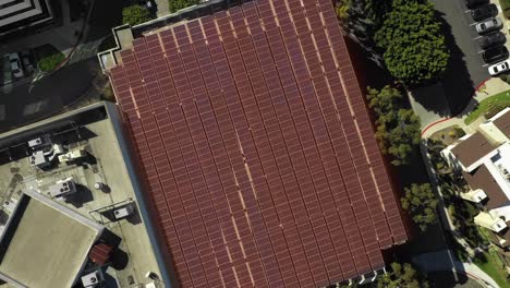 Solar-panel-on-top-of-parking-structure,-renewable-energy-with-motion-graphic,-aerial-birds-eye