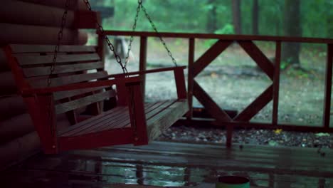 Blockhaus-Veranda-Schaukel-Im-Regen