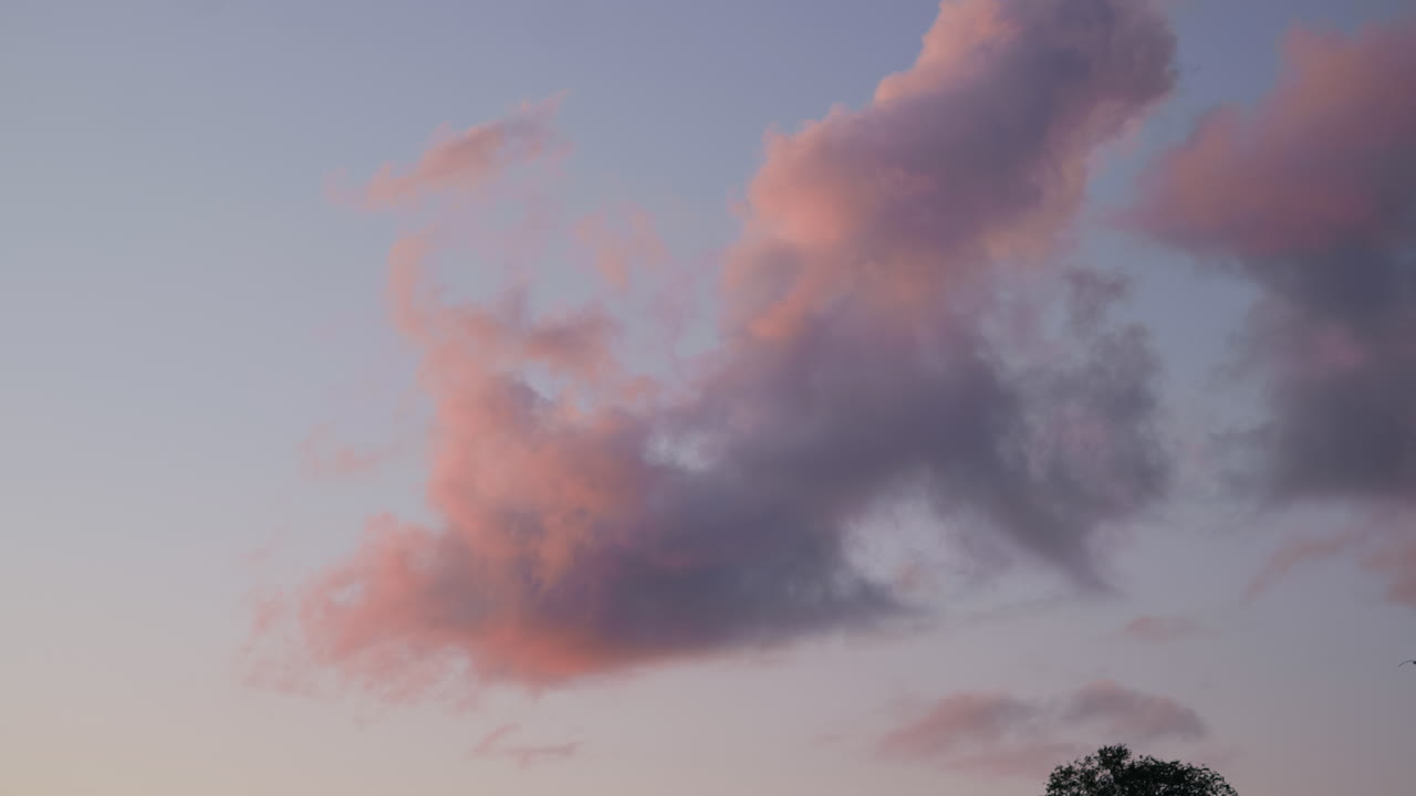 Clouds moving slowly in a sunset