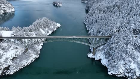 Wide-drone-shot-of-cars-driving-across-Deception-Pass-bridge-on-Whidbey-Island