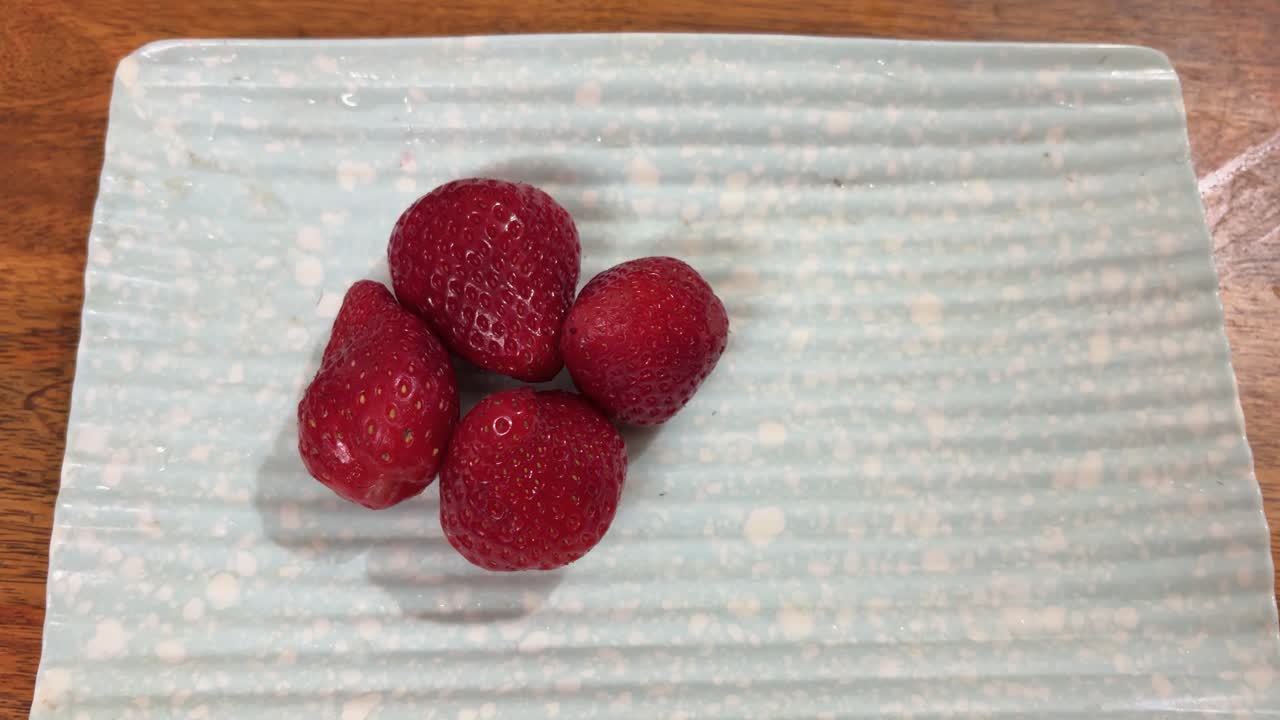 healthy fruit snack with strawberries in plate close up