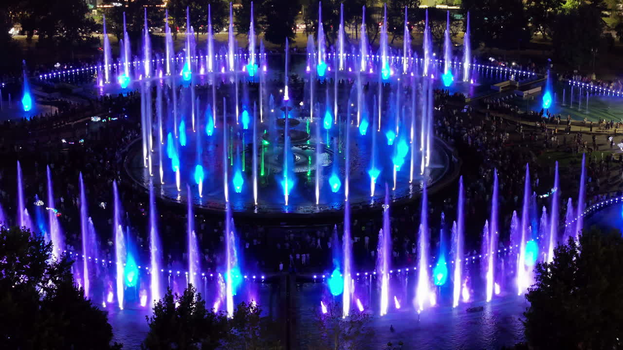 Aerial drone view of the illuminated Bucharest fountains in Romania, at night