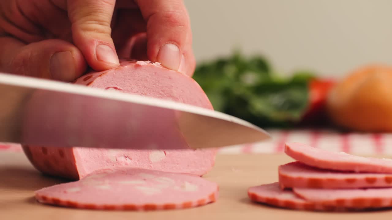 Ham italian mordatella, man Slices Of Traditional Italian antipasti mortadella sausage on a wooden cutting board, close up macro of chicken or turkey jamon, fat breakfast dish.