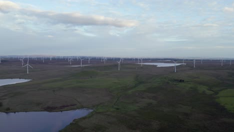 Aerial-push-in-to-windfarm-wind-turbines-spinning-on-Whitelee-moor