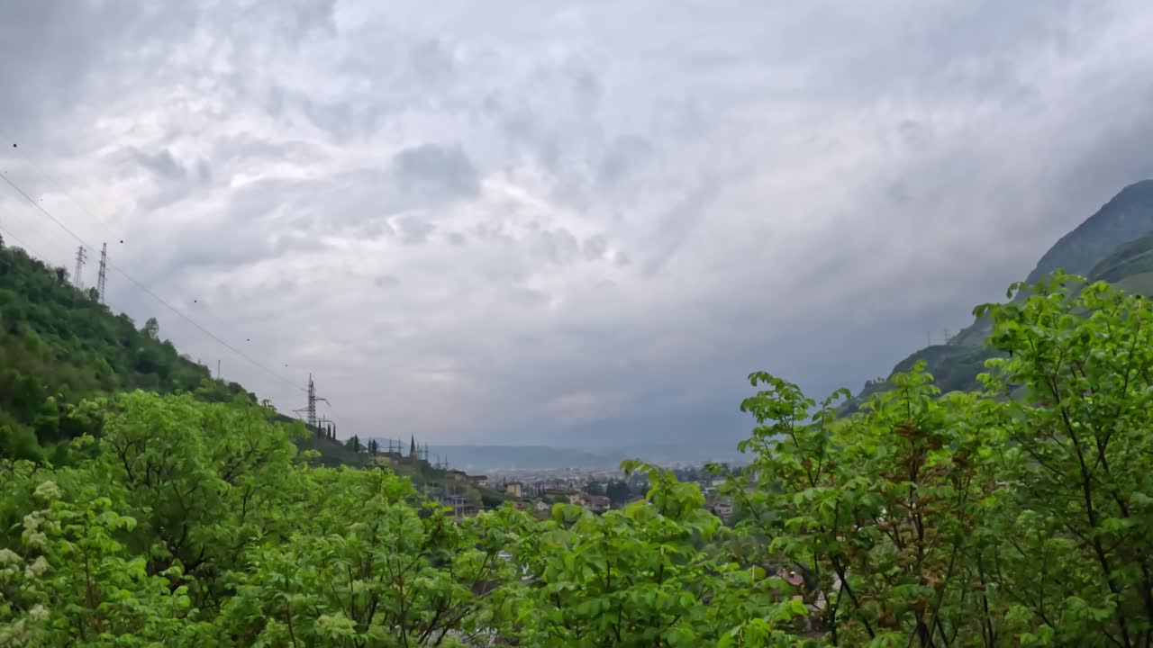 Lush green valley between two forested mountains near Castel Roncolo in Bolzano.