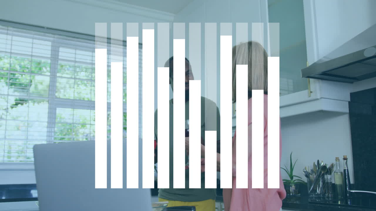 Couple holding wine glasses and chatting in kitchen, with animated tech chart floating over laptop