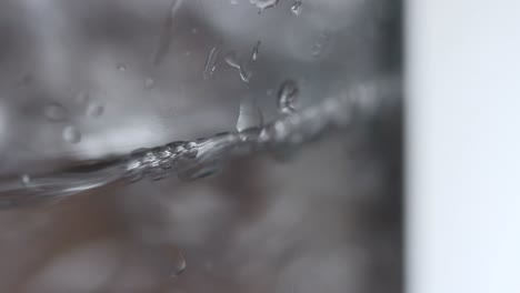 water is poured into a drinking glass