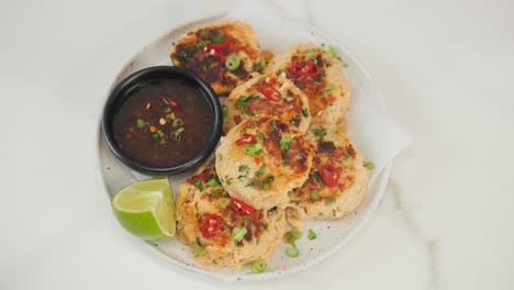 top-down view of a deliciously plated crab cake appetizer with garnish