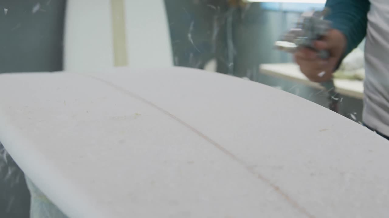 Male surfboard maker in his workshop