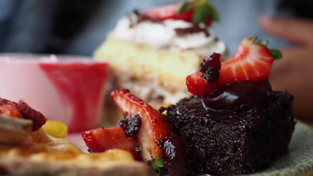 Assortment of Sweet Desserts Including Chocolate Cake and Fresh Strawberries