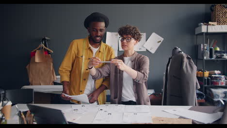 fashion designers collaborating on sketches