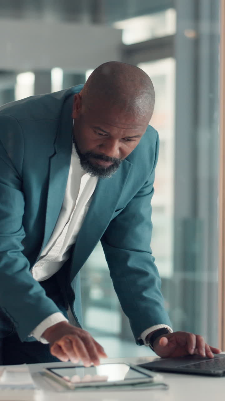 Homme d’affaires concentré utilisant une tablette numérique dans un bureau moderne