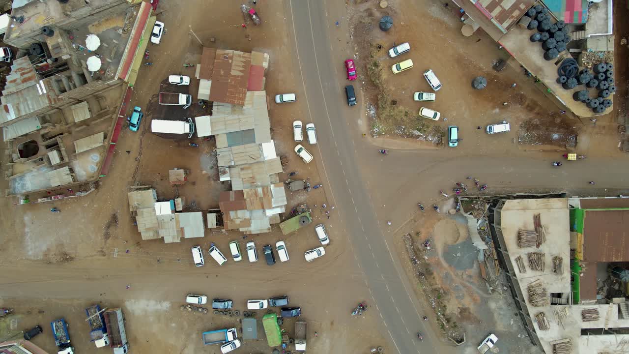 vista aérea de una ciudad y campos iluminados por el sol, hora dorada en áfrica rural - seguimiento, disparo de drones