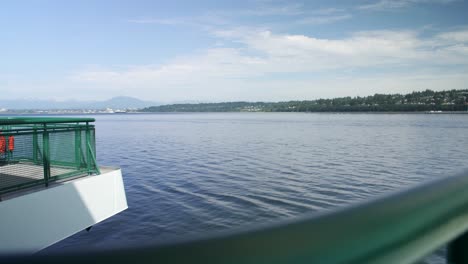 rising view over a ferry railing to reveal the puget sound