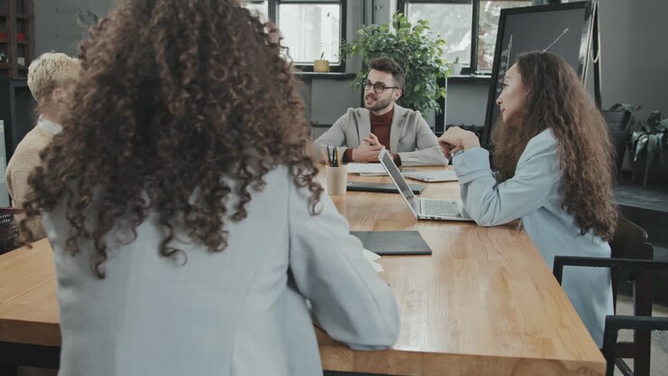 Diverse Business Partners Conferencing in Modern Room