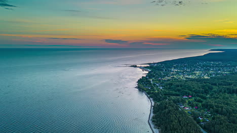 Woodland-At-The-Shore-Of-A-Coastal-Town-At-Sunset