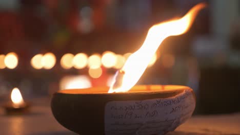 countless traditional candles burning infront of buddhist temple at nighttime during loy krathong festival in chiang mai, thailand