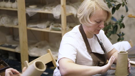 women working on pottery in a workshop