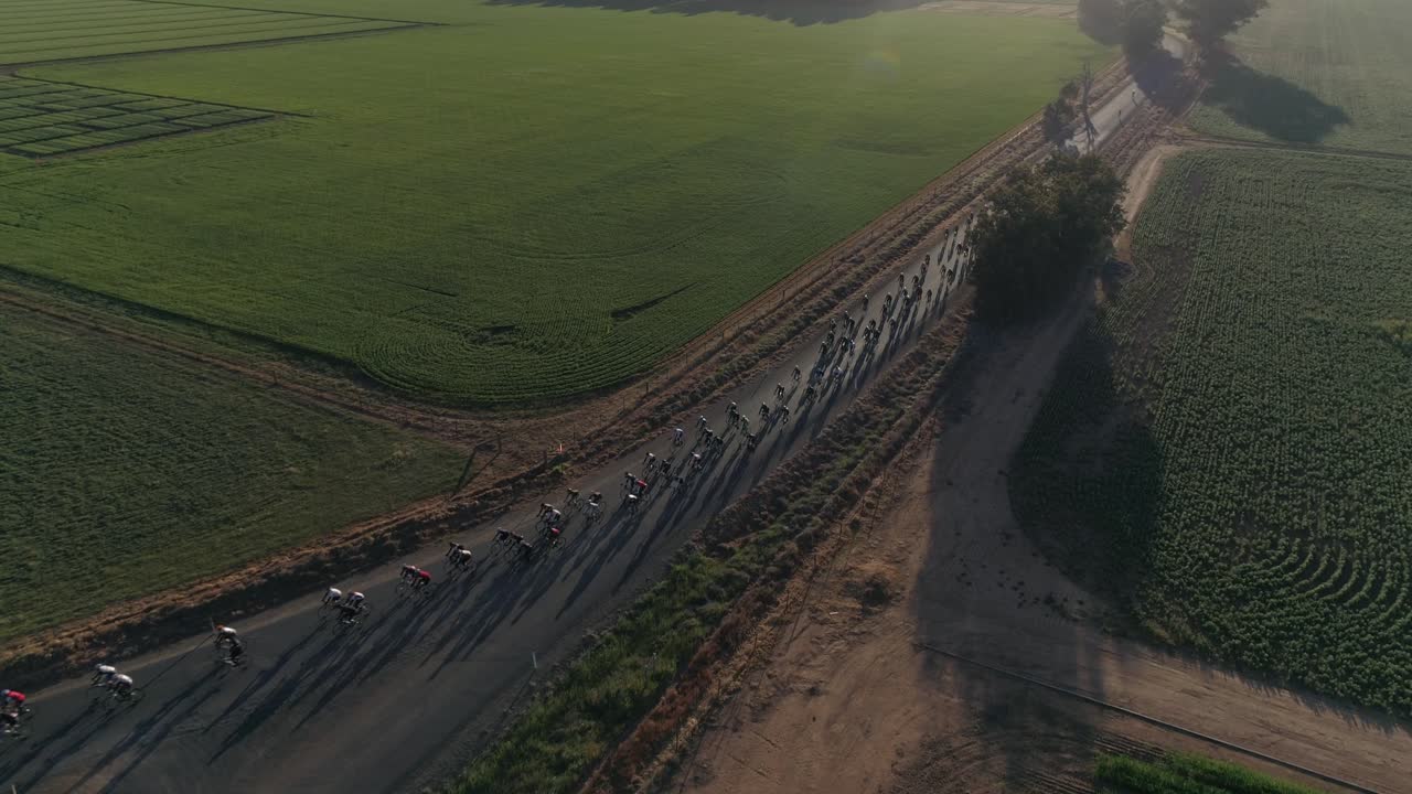 Aerial view of large group cyclist competing in the Gears and Beers race held in the rural city of Wagga Wagga NSW Australia surrounded by beautiful country landscape.