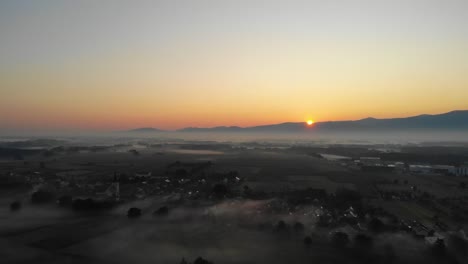 village surrounded by clouds of fog