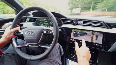 VINNITSA, UKRAINE - September 2019: Interior of Audi e-tron car with steering wheel and big screen. Presentation of a new model SUV Audi e-tron