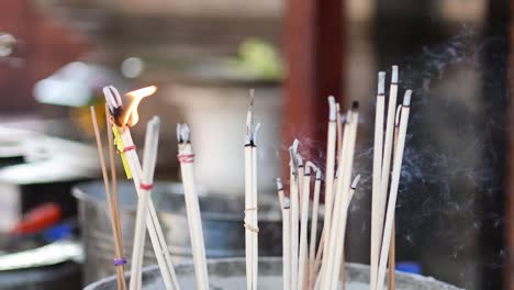 incense sticks burning in a pot