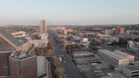 aerial cityscape with glass reflective building with traffic in the background