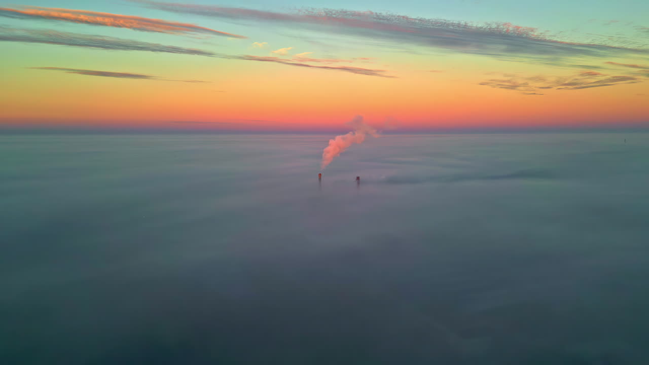 Aerial View of Industrial Smokestacks in a Foggy Sunset