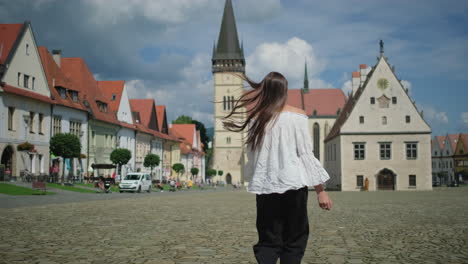 woman walking in a european town square