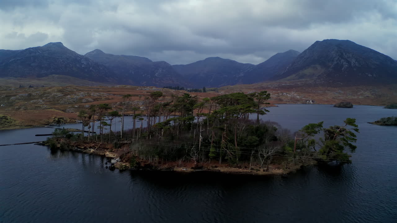 Wide-angle aerial view of Pine Island on Derryclare Lough, showcasing Connemara’s dramatic landscape, Ireland