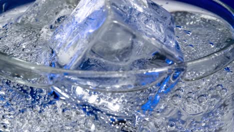 glass of water with ice on a dark blue background