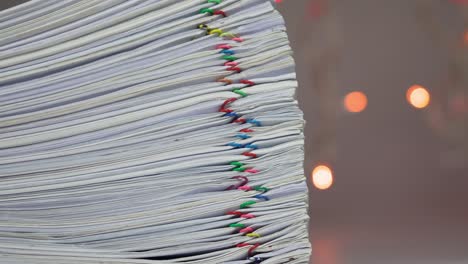 stack of paperwork have colorful bokeh as background time lapse