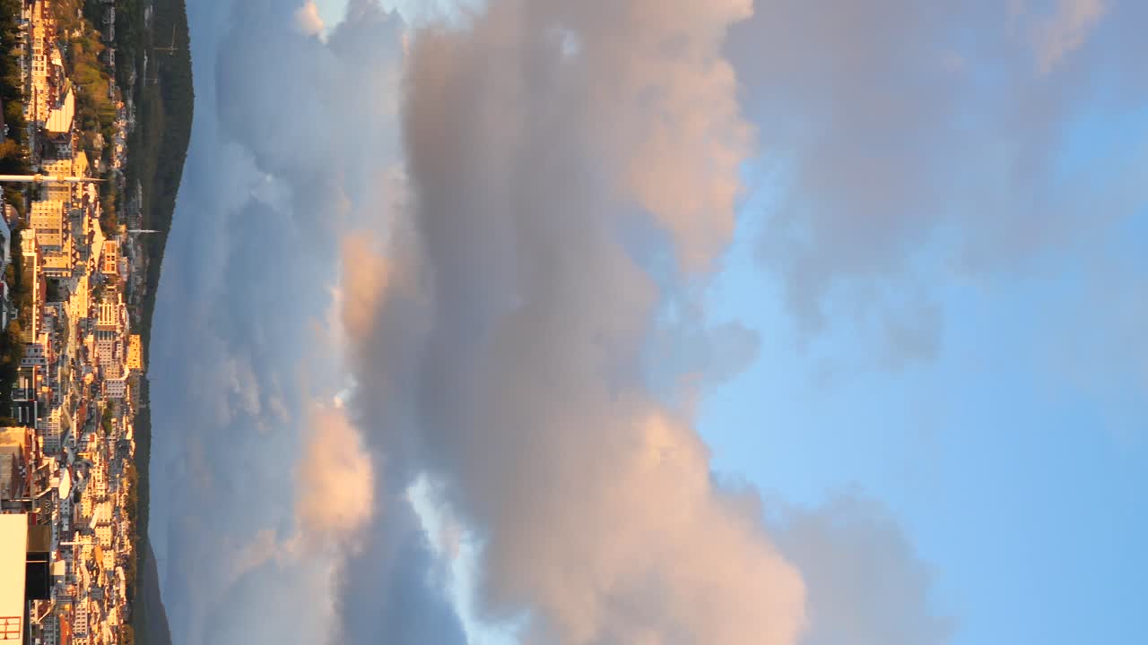 Cityscape with Dramatic Clouds at Sunrise/Sunset