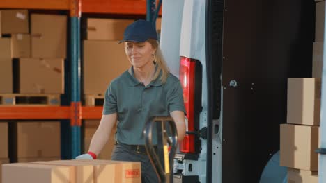 portrait of beautiful white woman worker loading delivery track with cardboard boxes. happy professional working in logistics retail center, delivering e-commerce online orders, food, medicine supply