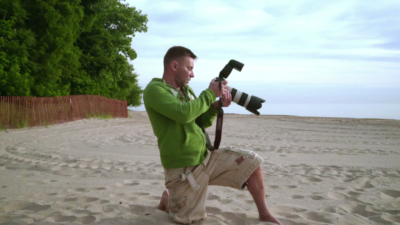 Photographer takes photo on sea beach. Photographer working