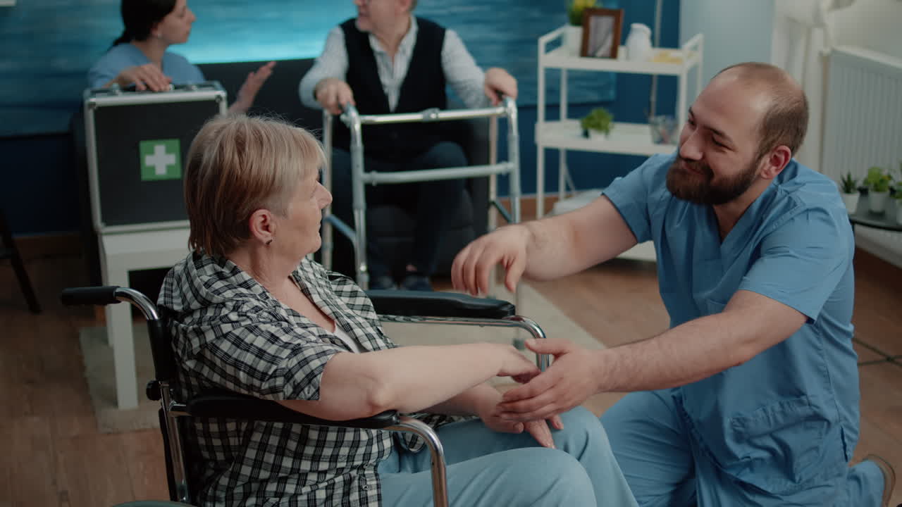 Man nurse comforting senior woman with handicap
