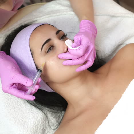 hands of cosmetologist making injection in face. rejuvenating facial injections. aesthetic cosmetology.