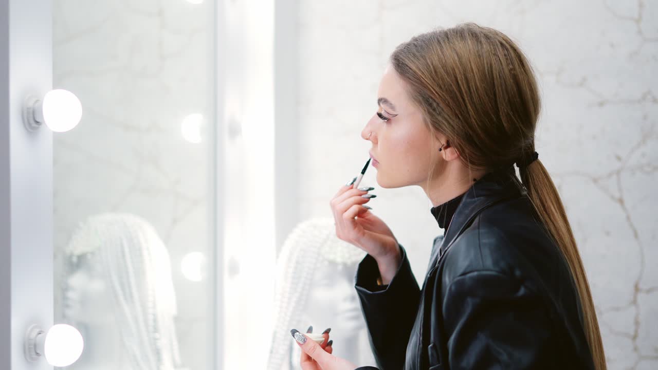 Young Woman Applying Makeup in a Beauty Studio