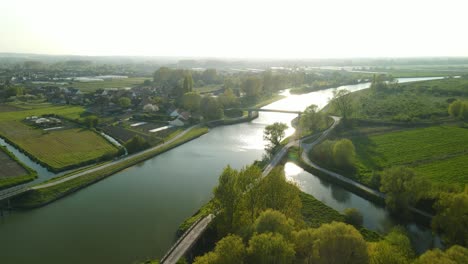 Aerial-view-in-the-sunset-of-a-river-in-Clairmarais,-France