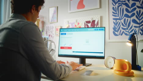 person working on computer with image generator software