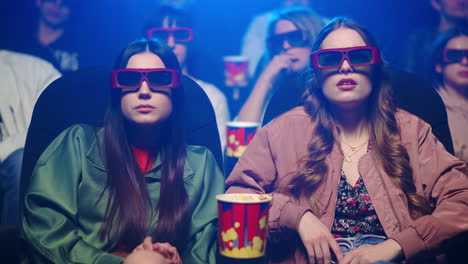 shocked women watching film in cinema