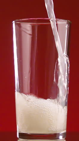 pouring soda into a glass