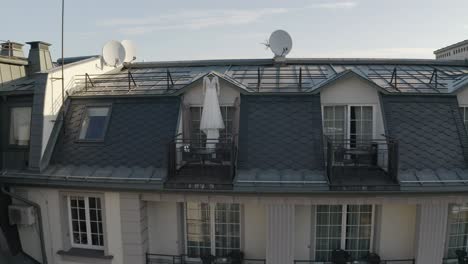 White-wedding-dress-hangs-on-special-hanger-in-doorway-of-balcony-of-luxury-house,-aerial-view